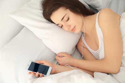 woman sleeping with earbuds